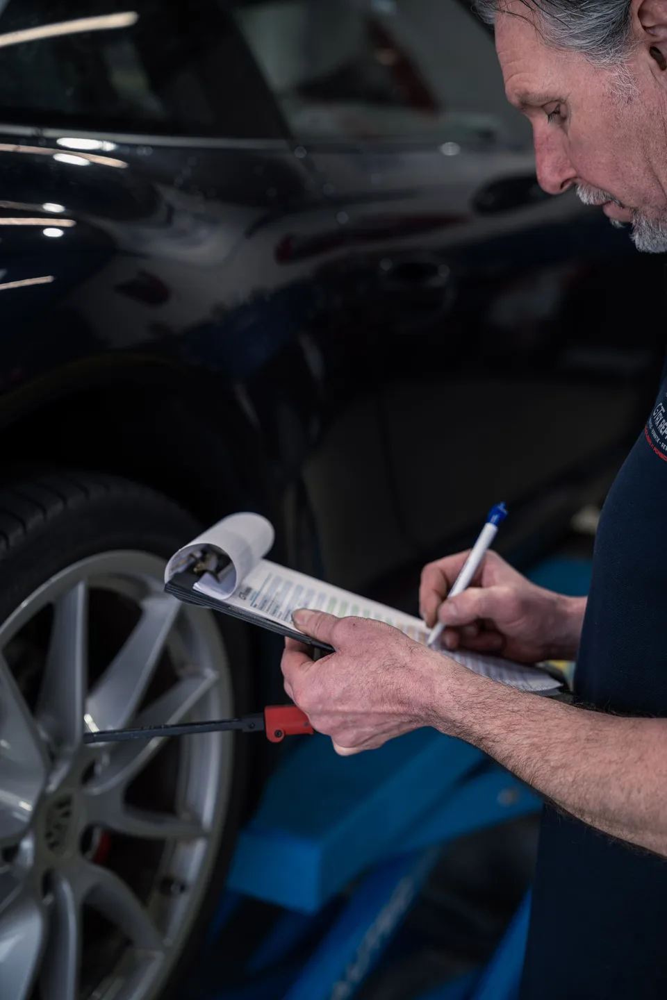 Mechanic checking the paintwork up close