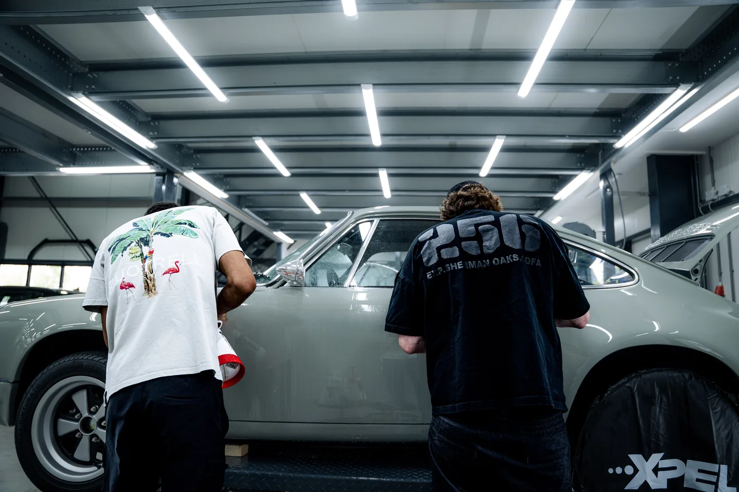 Team applying vinyl to a white car