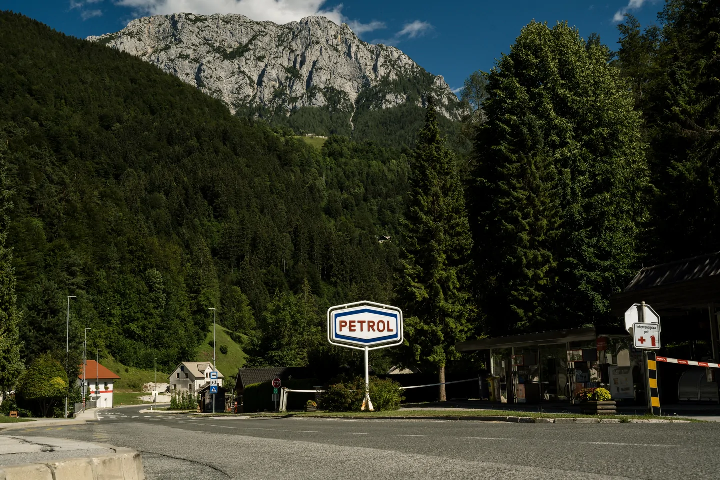 Classic petrol station sign in a mountain landscape