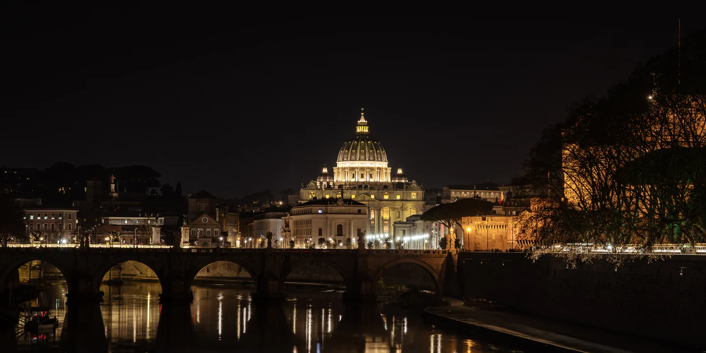 St Peter’s Basilica illuminated beside the river at night