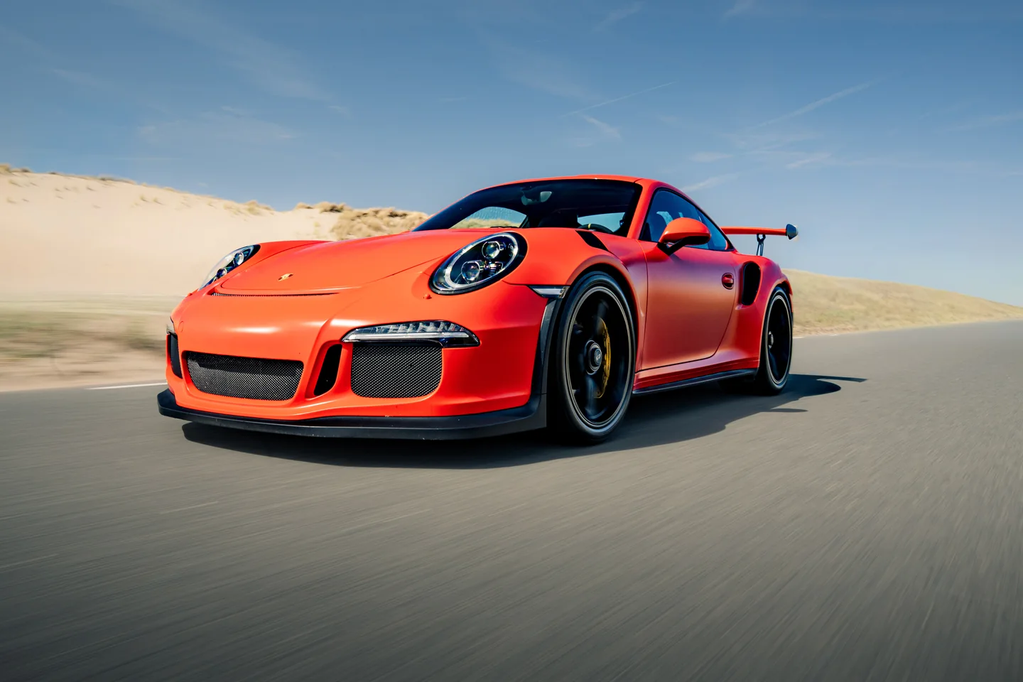 Red Porsche photographed in motion