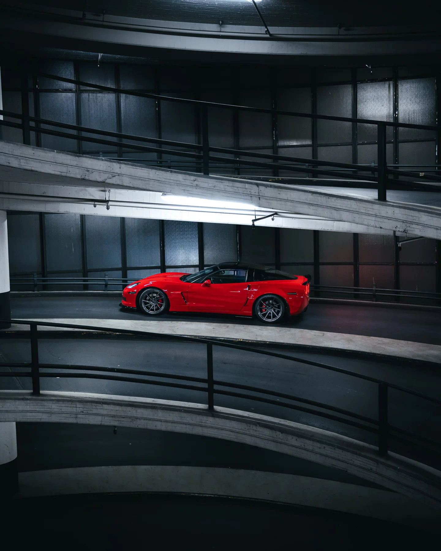 Red Corvette on a parking-garage ramp