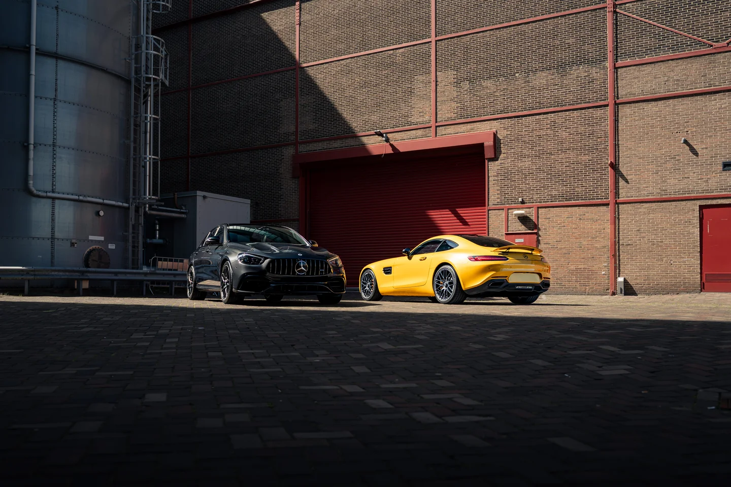Two sports cars at an industrial location